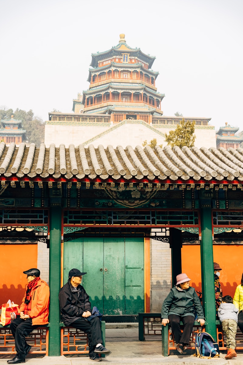 people standing near green and brown wooden building during daytime